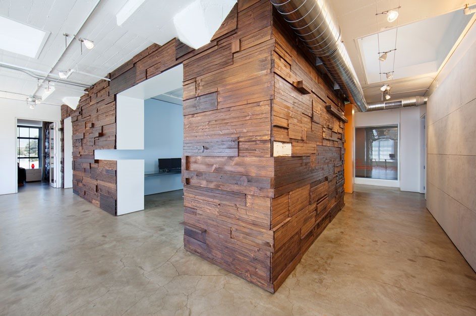A reclaimed timber volume set into the penthouse floor plate, forming an enclosed meeting room.